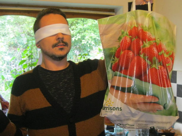 blindfolded customer with Morrisons bag