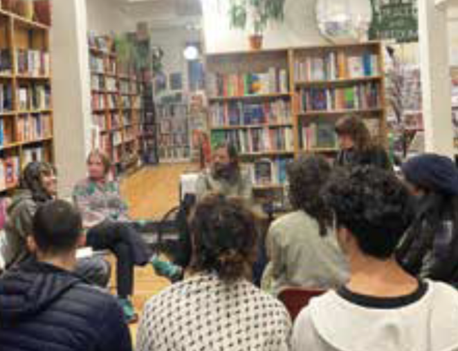 Bookshelves and audience at Housmans